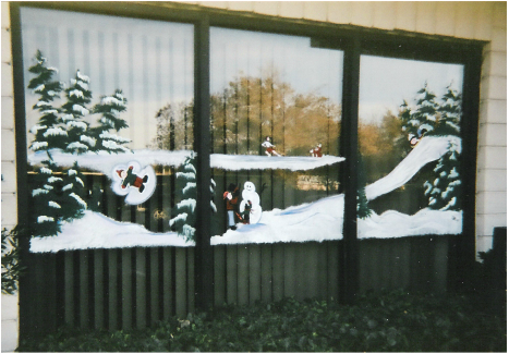 snow scene window painting with different scenes of snow play: skating, sledding, snowman building, making a snow angel. Image: M Burgess - window painter
